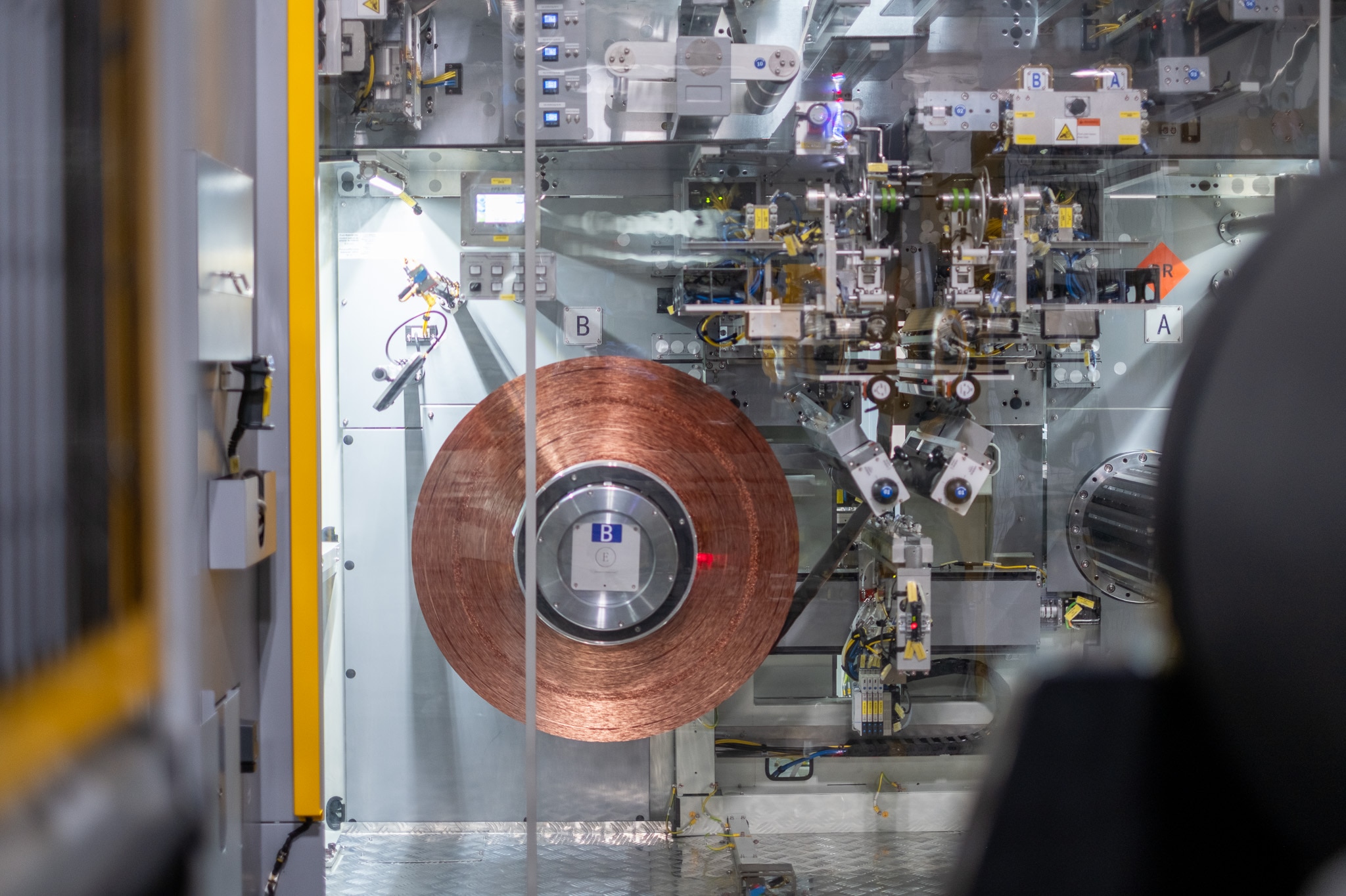 An anode roll is pictured in a tab forming machine.