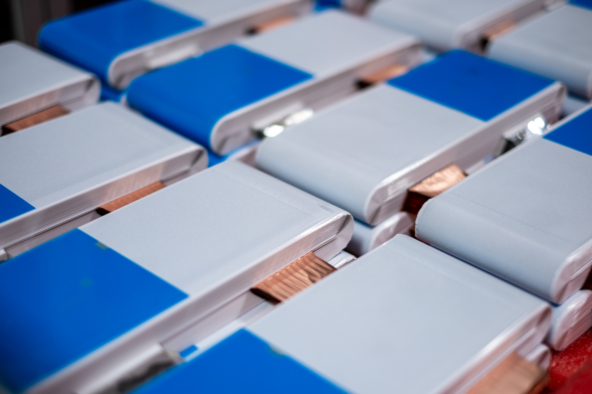 Jelly rolls — pictured with copper and aluminum tabs visible — are the final product from winding machines. Two jelly rolls are assembled into each battery cell.